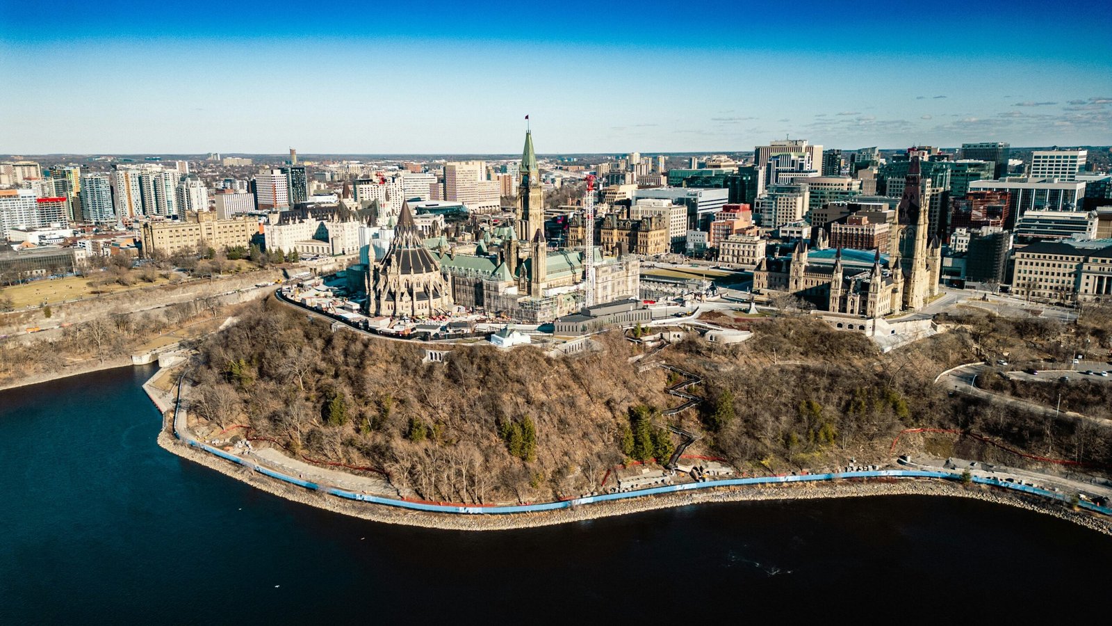 An aerial view of a city with a lake in the foreground